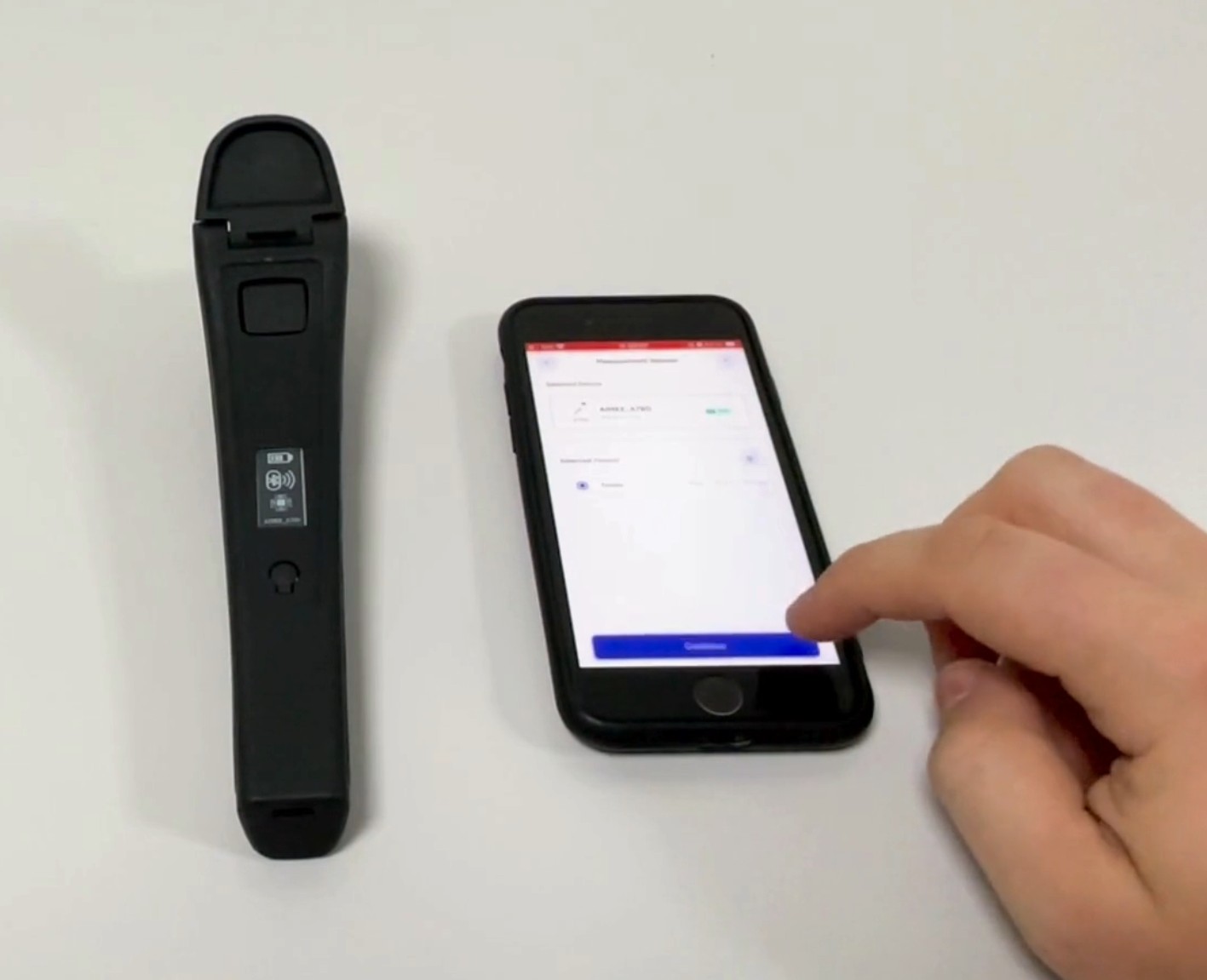 Physical aimee Reader beside an iPhone displaying the app prototype